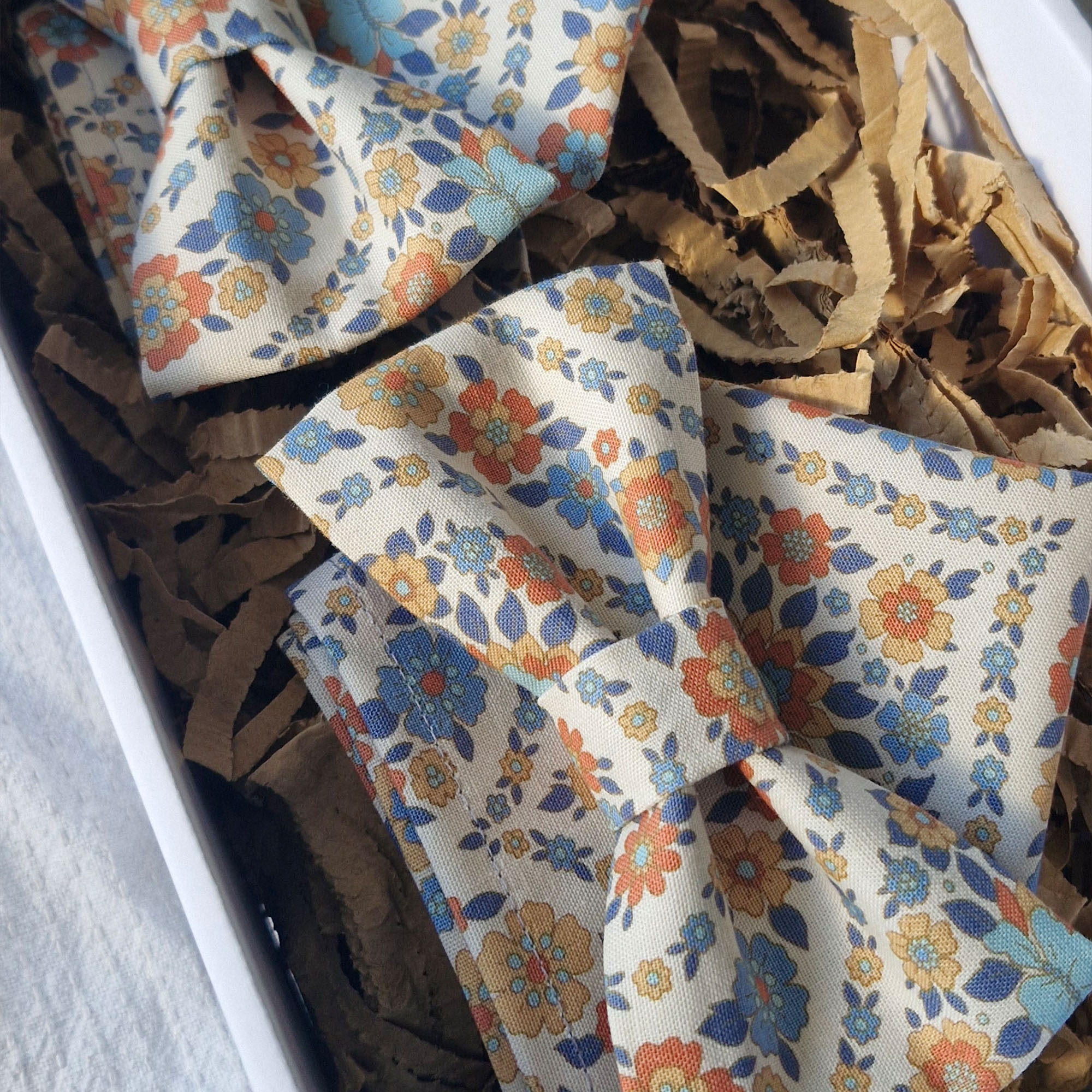 Untitled A set of matching orange and blue floral bowties and pocket squares
